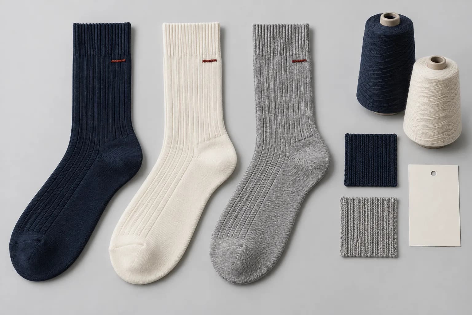 Illustrative crew socks, yarn and knit swatches for reviewing a repeat order's product specification
