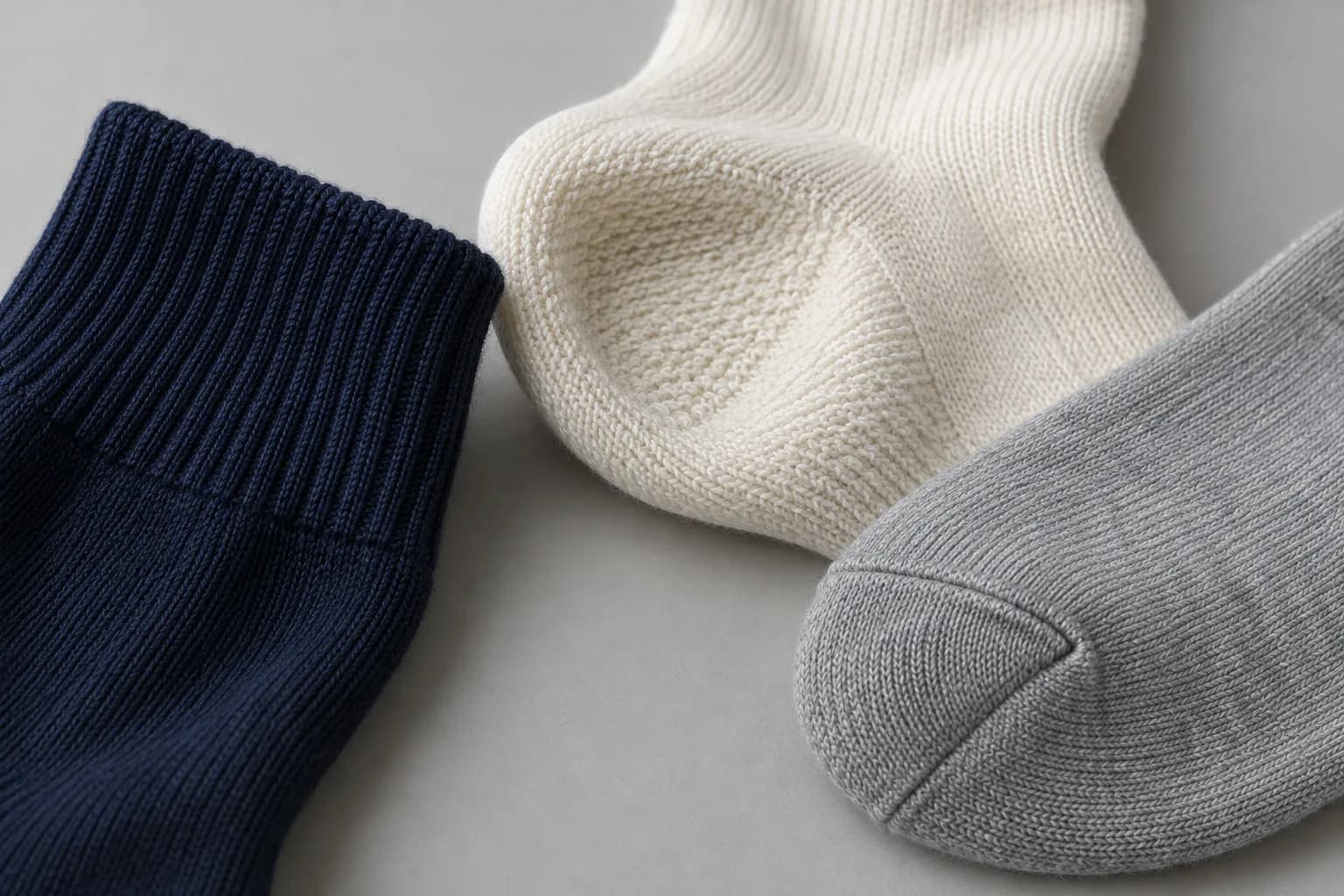 Illustrative close-up of a ribbed cuff, looped heel texture and smooth-knit toe